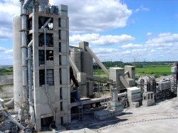 Plant overview, showing preheater tower (left), CF silo (far left behind pre-heater tower), coarse clinker silos (centre top), kiln (centre below) and clinker cooler (far right).