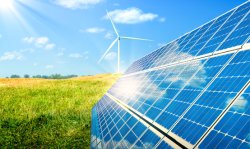 Wind Turbines In Grassy Field With Sunlight. Source: Shutterstock