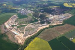 View over the plant’s extensive quarry with plant in the background and solar farm (ringed) in the centre.