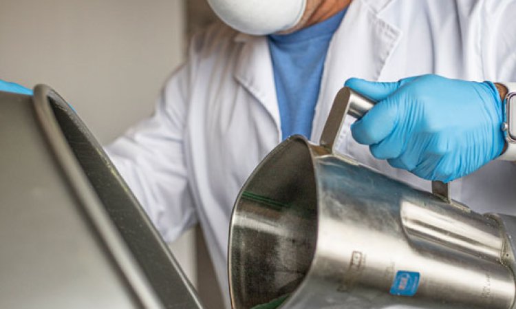 Vaughn Bigelow, Prometheus Materials’ VP of Manufacturing, pours microalgae into a laboratory-scale reactor.